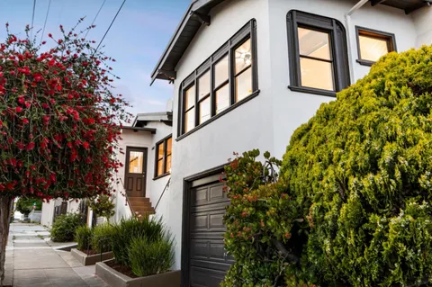 a view of a house with a flower garden