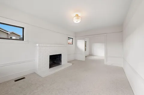 a kitchen with granite countertop white cabinets and white stainless steel appliances