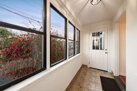 a view of a room with wooden floor and windows