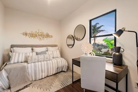 a bedroom with a large bed and a window