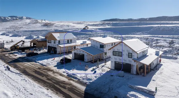 an aerial view of a house with a mountain
