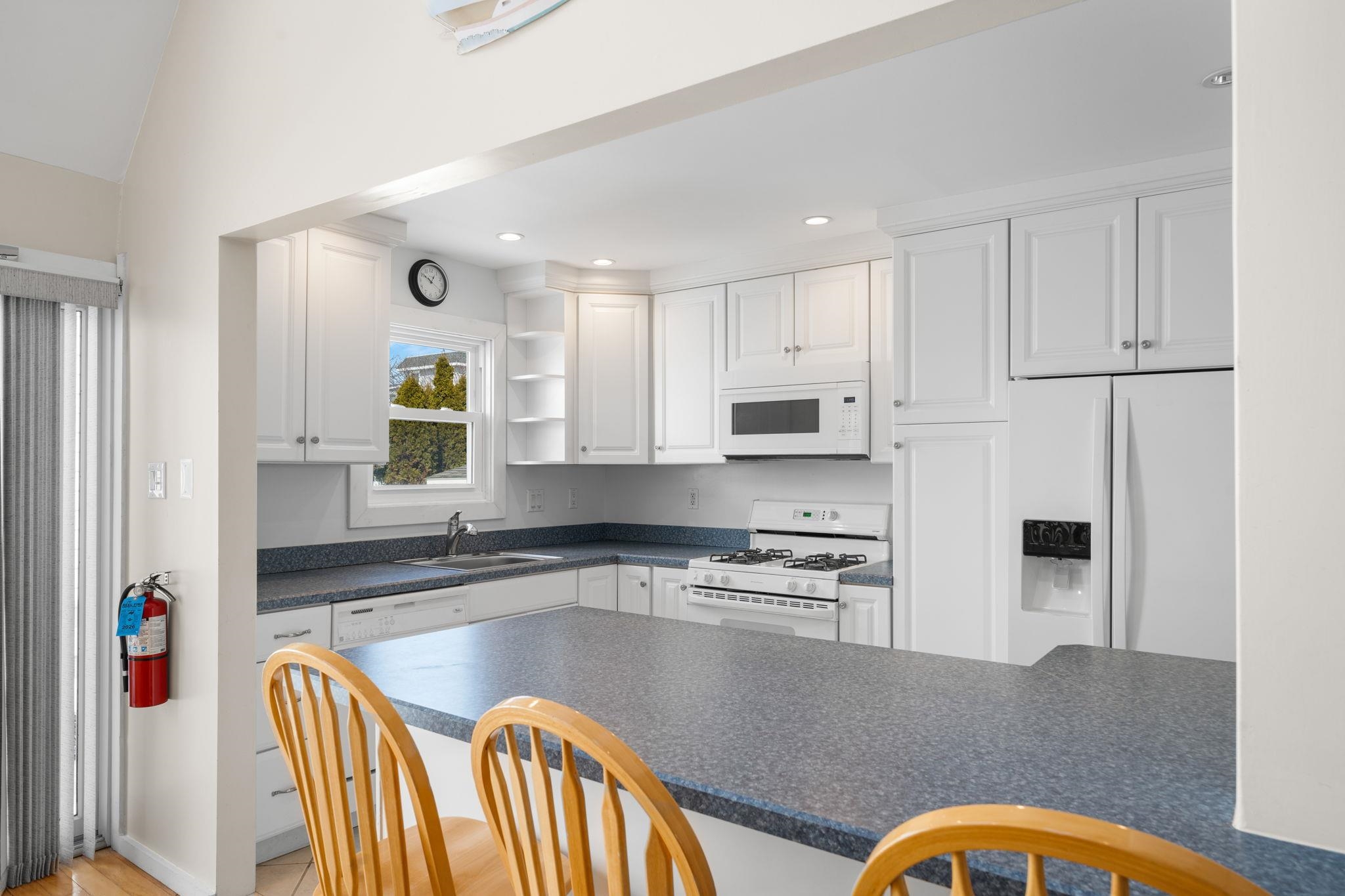 45 19th Street Avalon, NJ 08202 - Photo 12 of 50 a kitchen with stainless steel appliances granite countertop a refrigerator a stove top oven and a sink with wooden floor