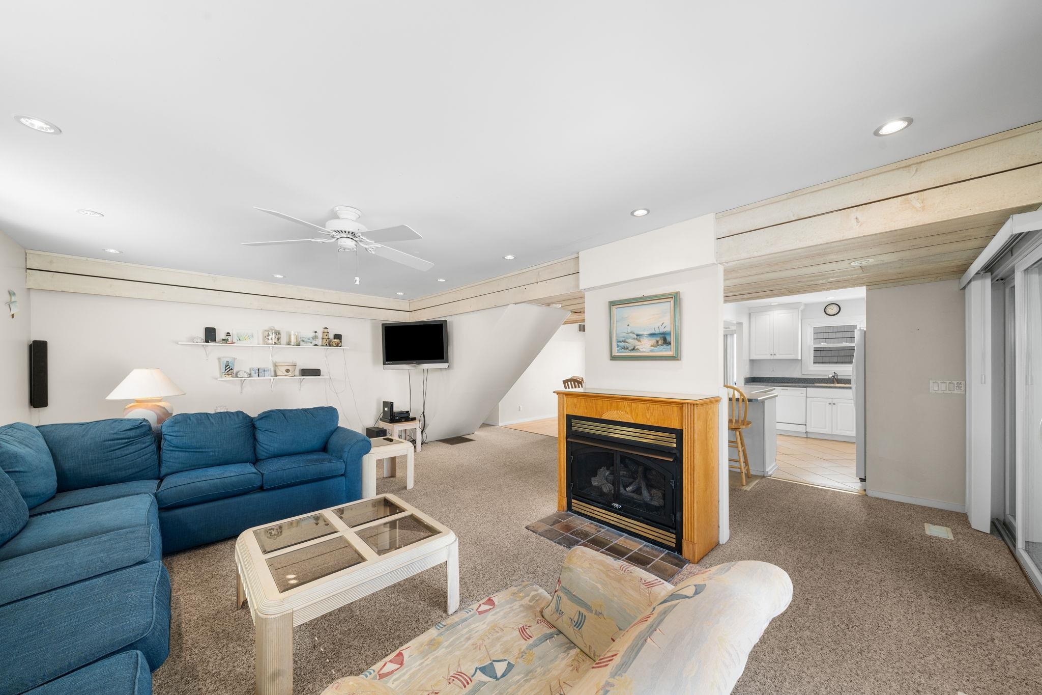 45 19th Street Avalon, NJ 08202 - Photo 17 of 50 a living room with furniture a flat screen tv and a fireplace
