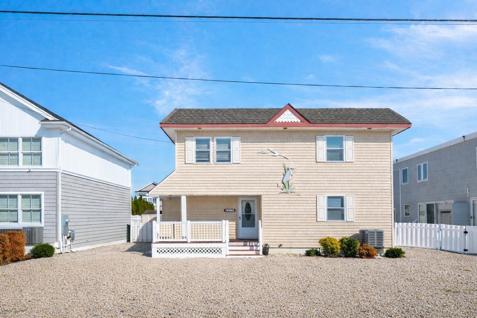 45 19th Street Avalon, NJ 08202 - Photo 2 of 50 a front view of a house with a garage