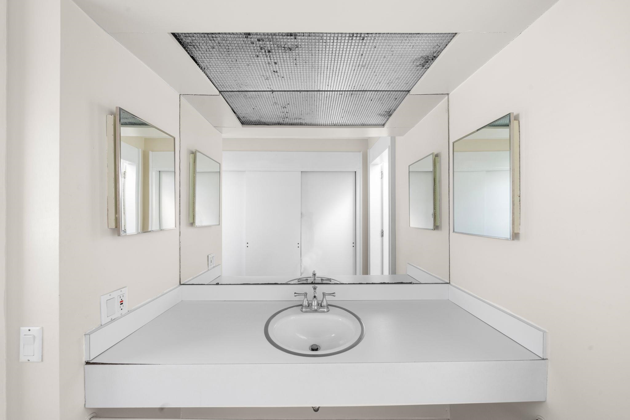 45 19th Street Avalon, NJ 08202 - Photo 27 of 50 a bathroom with a sink and a mirror