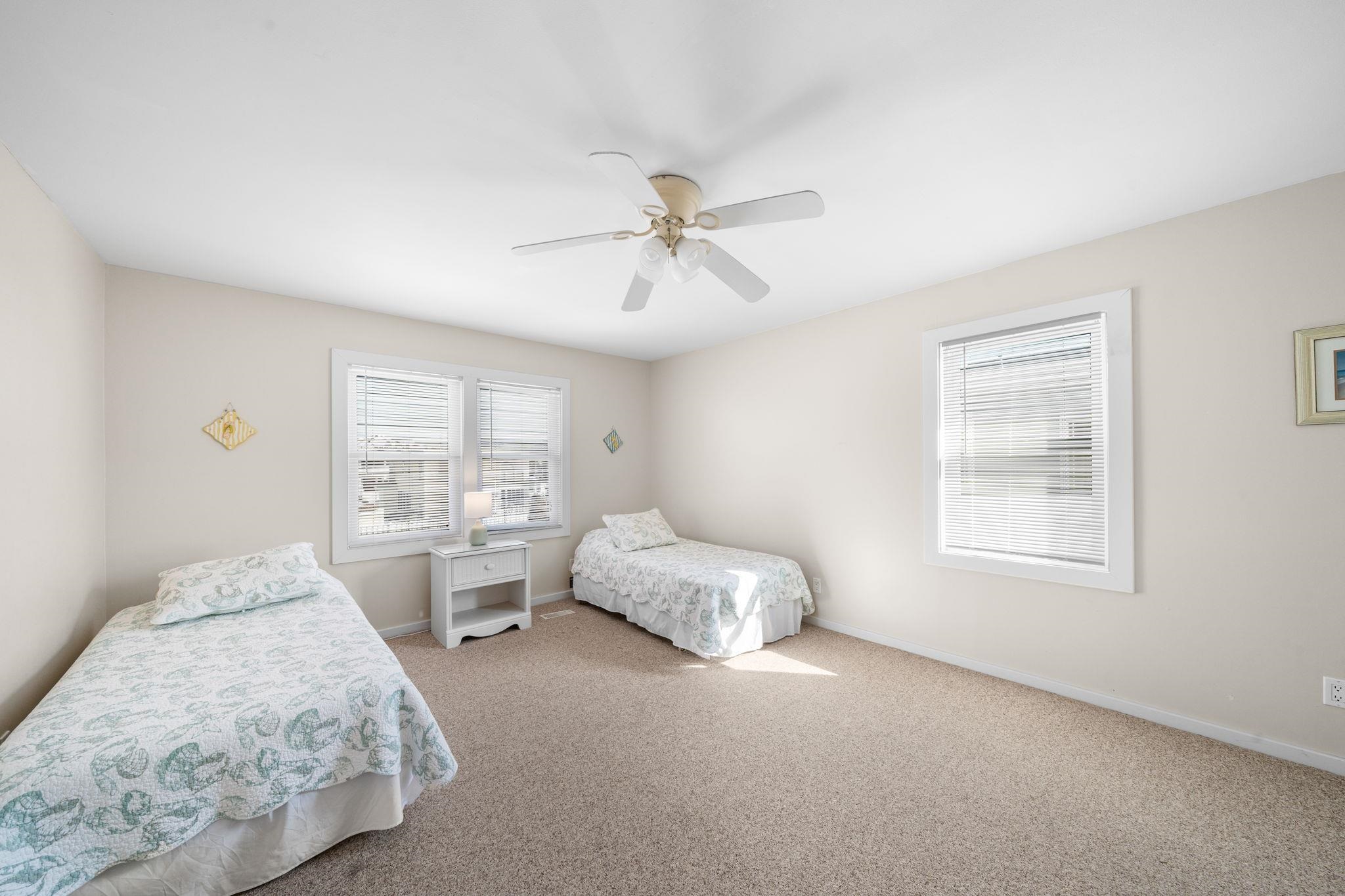 45 19th Street Avalon, NJ 08202 - Photo 29 of 50 a spacious bedroom with a bed and window