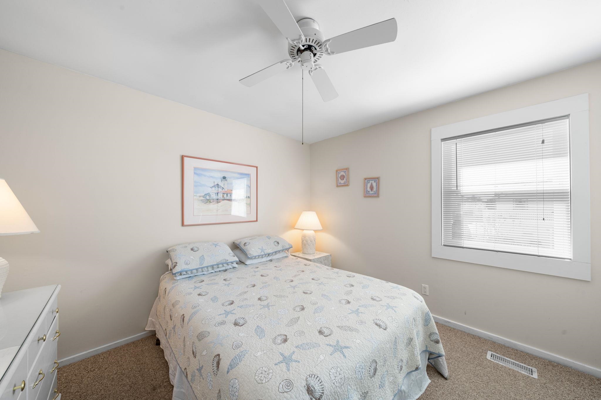 45 19th Street Avalon, NJ 08202 - Photo 37 of 50 a bedroom with a bed and a window