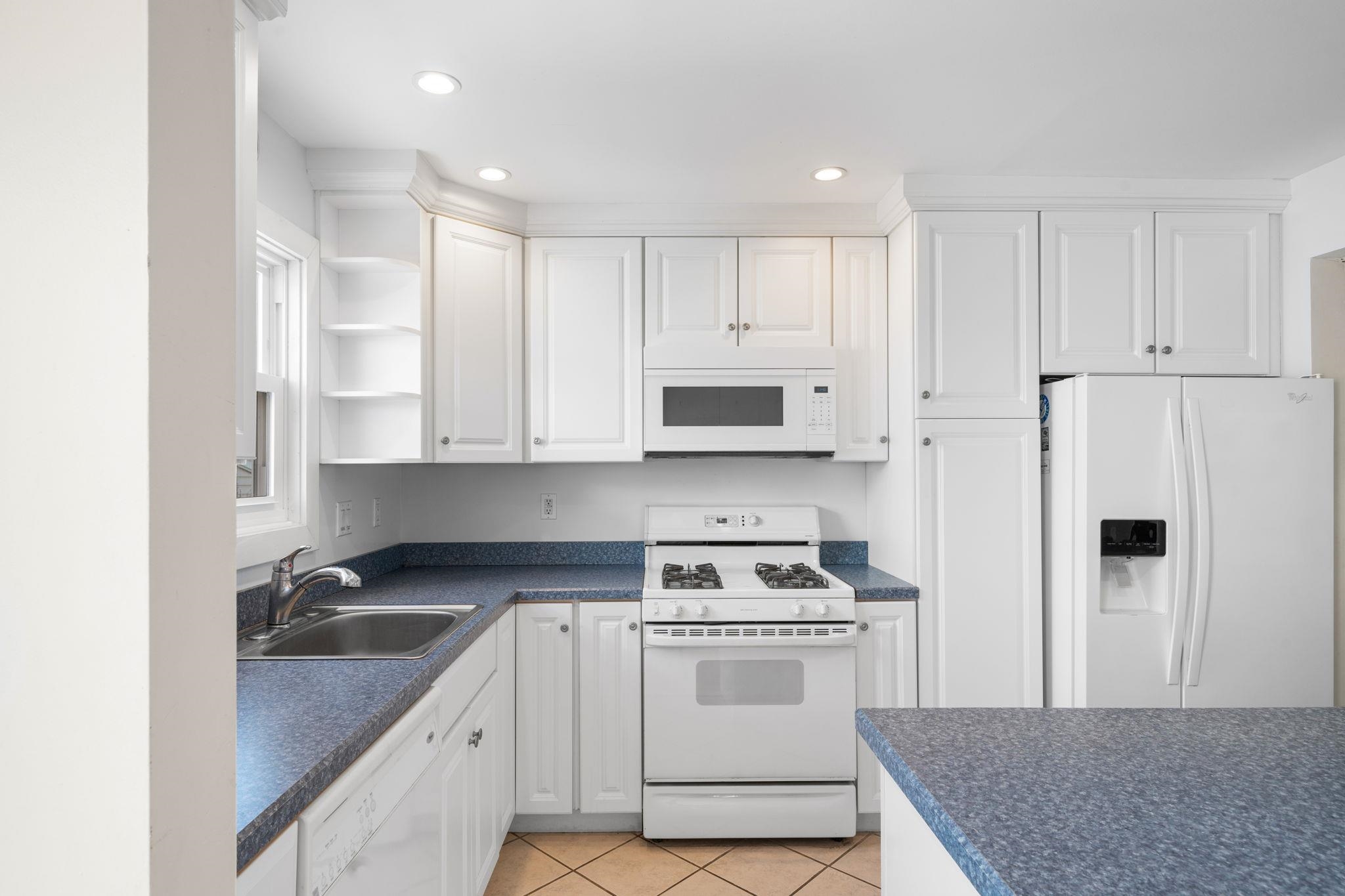 45 19th Street Avalon, NJ 08202 - Photo 9 of 50 a kitchen with stainless steel appliances granite countertop a sink stove and refrigerator