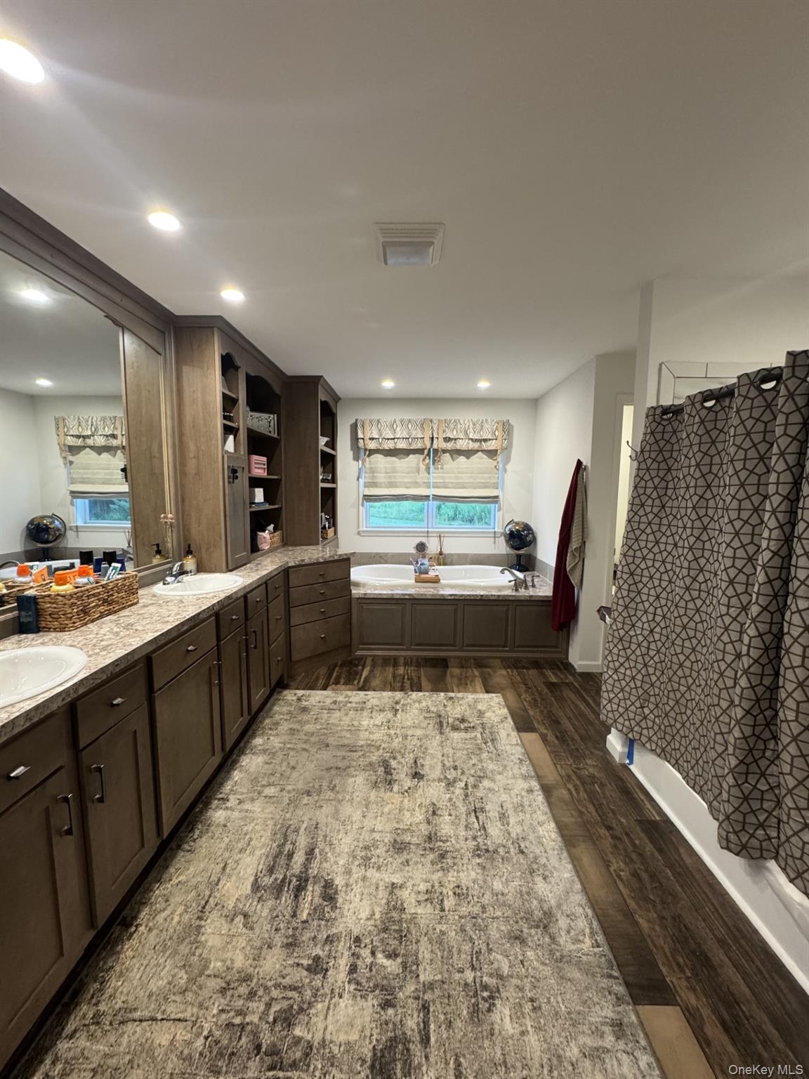 155 Metzger Road Red Hook, NY 12571 - Photo 18 of 29 Full bathroom with a garden tub, double vanity, dark wood-style floors, recessed lighting, and curtained shower