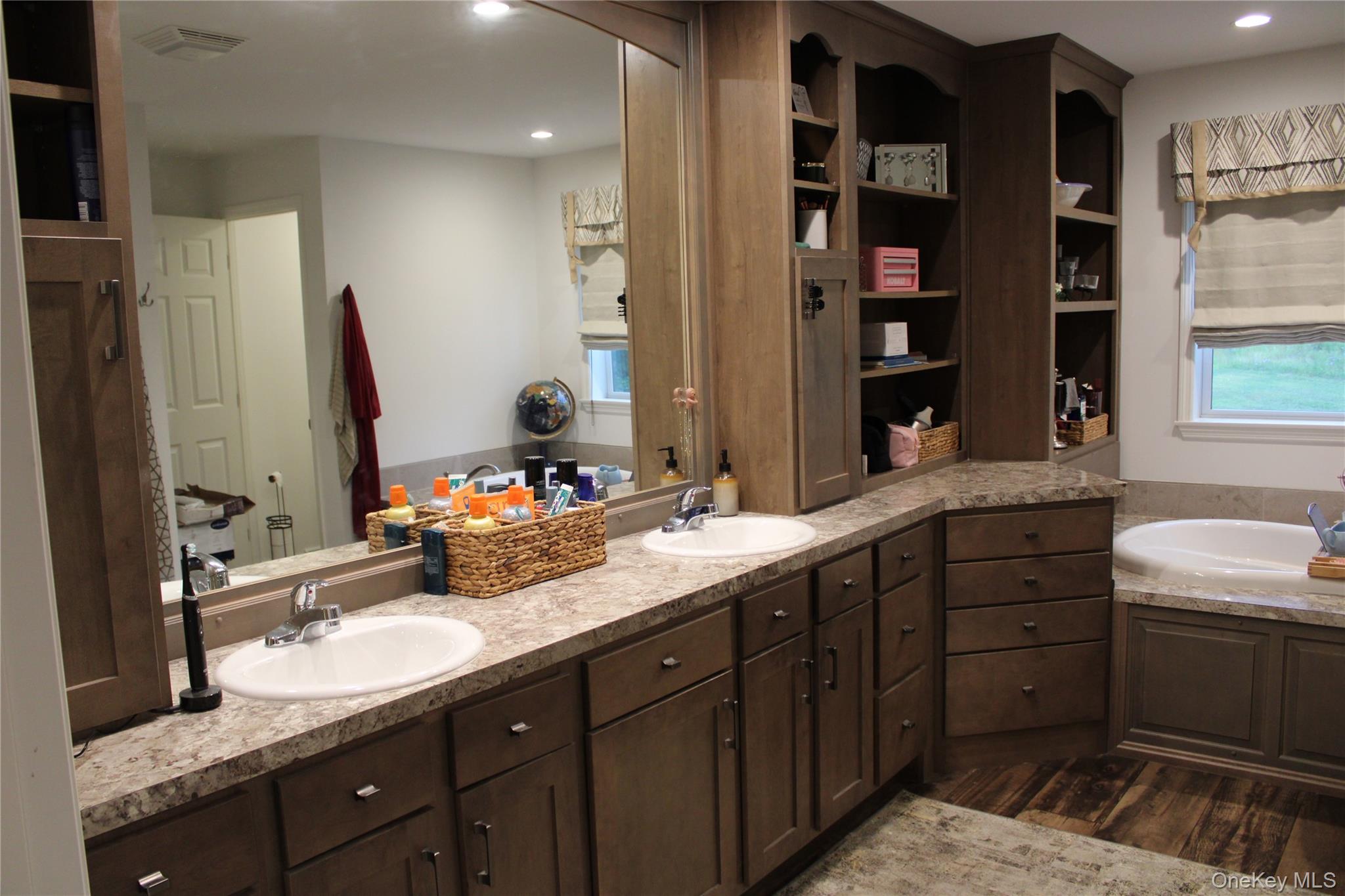 155 Metzger Road Red Hook, NY 12571 - Photo 20 of 29 Bathroom with healthy amount of natural light, double vanity, dark wood-style flooring, a bath, and recessed lighting