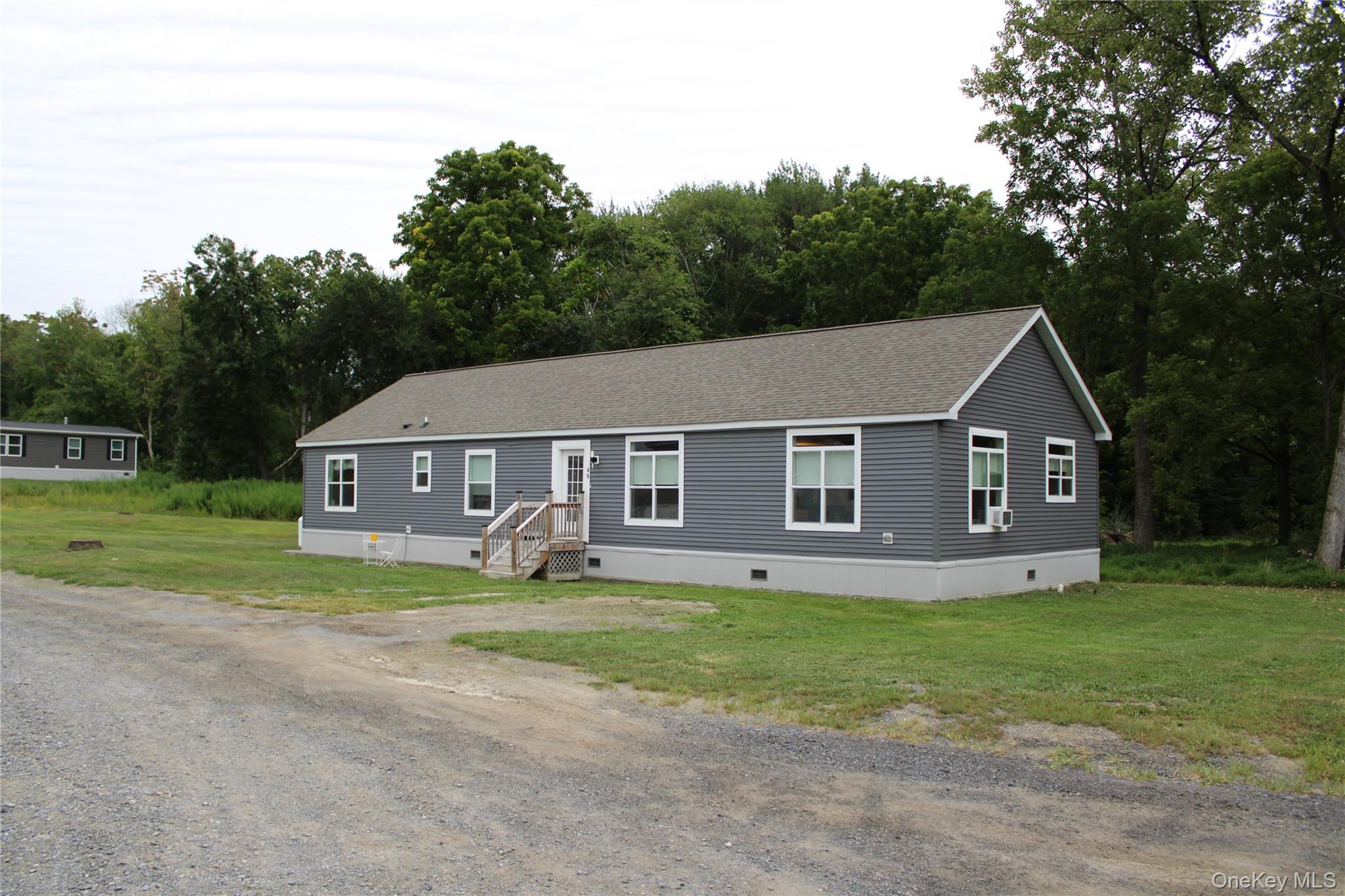155 Metzger Road Red Hook, NY 12571 - Photo 2 of 29 Manufactured / mobile home with crawl space, a front yard, roof with shingles, and driveway
