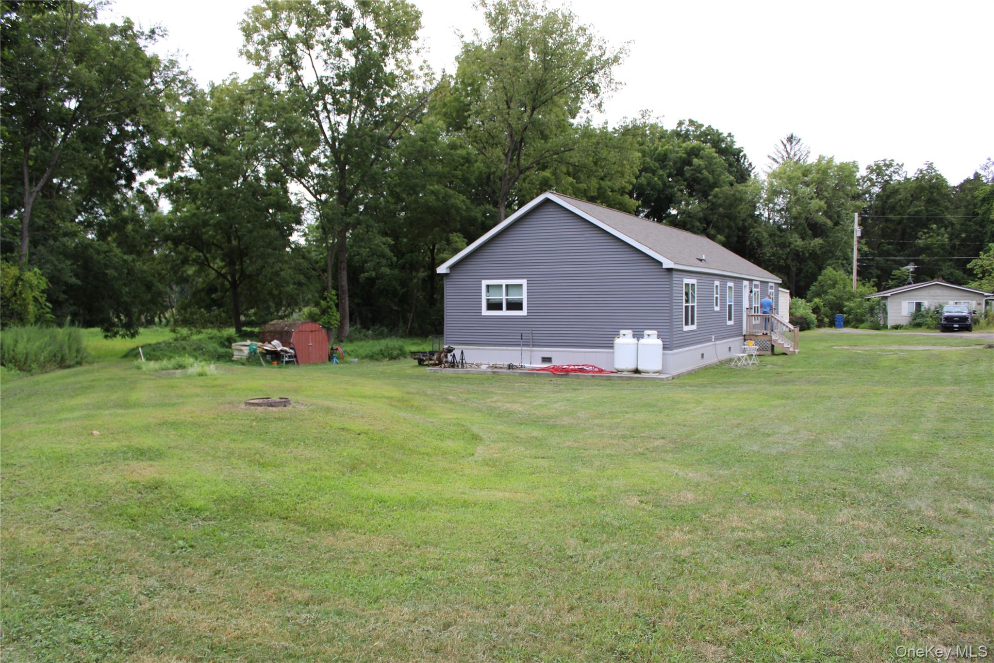 155 Metzger Road Red Hook, NY 12571 - Photo 7 of 29 View of grassy yard with a storage shed and view of scattered trees