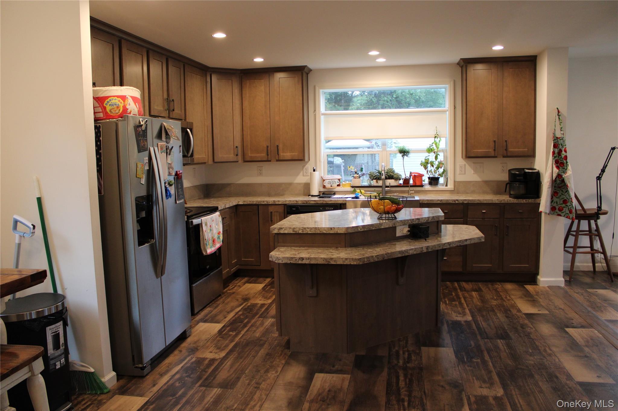 155 Metzger Road Red Hook, NY 12571 - Photo 10 of 29 Kitchen with appliances with stainless steel finishes, dark wood-style flooring, a kitchen island, recessed lighting, and a kitchen breakfast bar