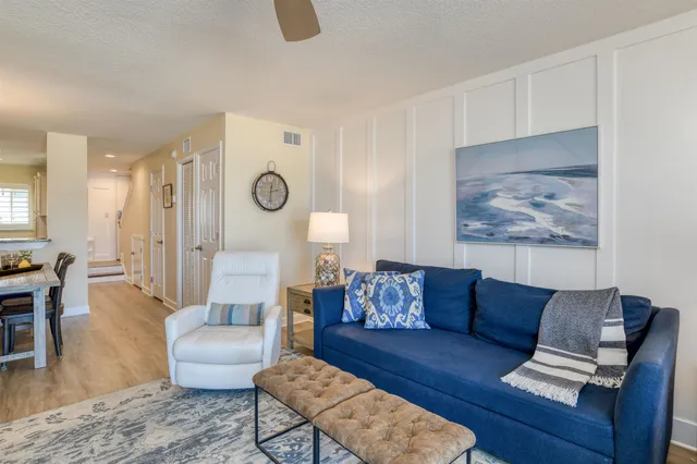 a living room with furniture and a lamp