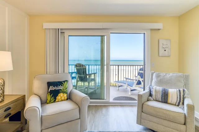 a balcony with wooden floor and outdoor space