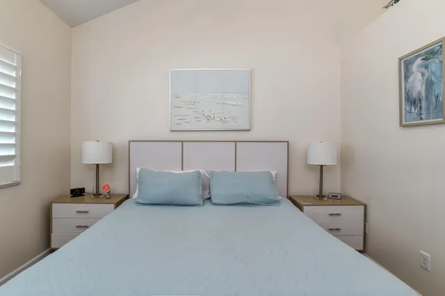 a bedroom with bed and cupboard