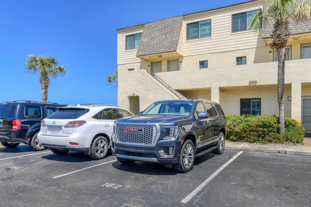 a kitchen with granite countertop a stove a sink and a microwave