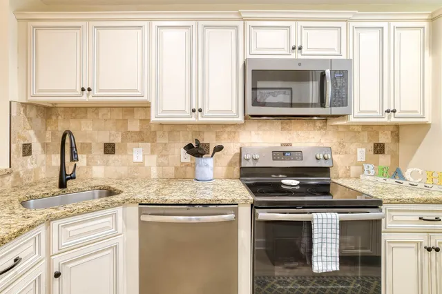 a kitchen with a stove microwave and refrigerator
