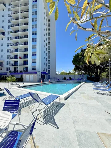 a view of a patio with couches table and chairs and potted plants