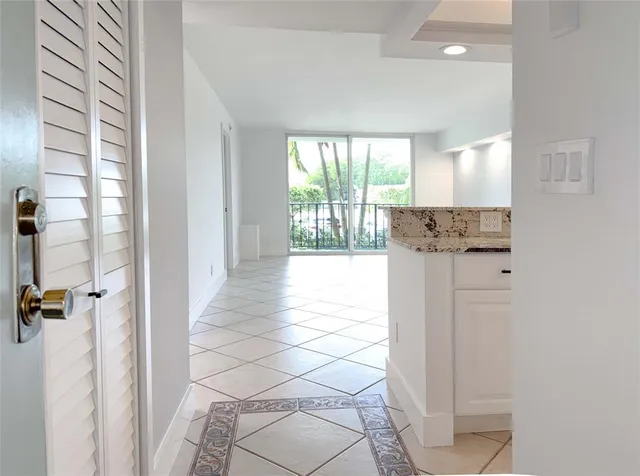 a kitchen with stainless steel appliances granite countertop a stove and white cabinets