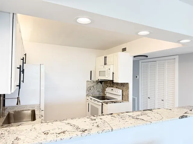 a kitchen with a sink stove and refrigerator