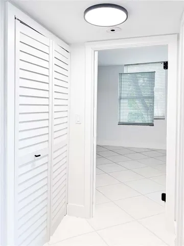 a view of a livingroom with an empty space and a window