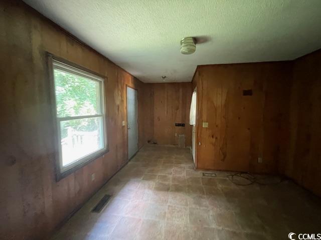 41 Harmon Street Hemingway, SC 29554 - Photo 12 of 20 Unfurnished room with wooden walls and a textured ceiling