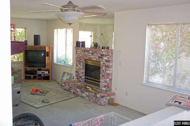 1412 Keystone Avenue Reno, NV 89503 - Photo 4 of 6 a living room with furniture a flat screen tv and a fireplace