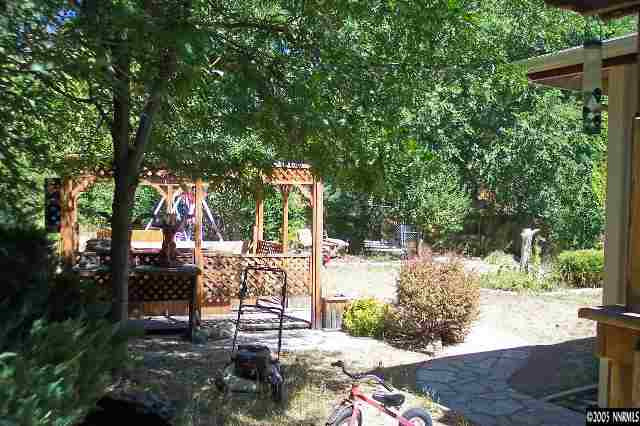 1412 Keystone Avenue Reno, NV 89503 - Photo 6 of 6 a view of a patio with table and chairs potted plants and large tree