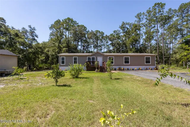 a swimming pool view with a seating space and a garden