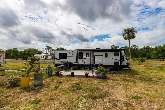 a view of a house with swimming pool and sitting area