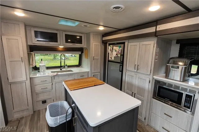 a kitchen with stainless steel appliances a stove microwave and refrigerator