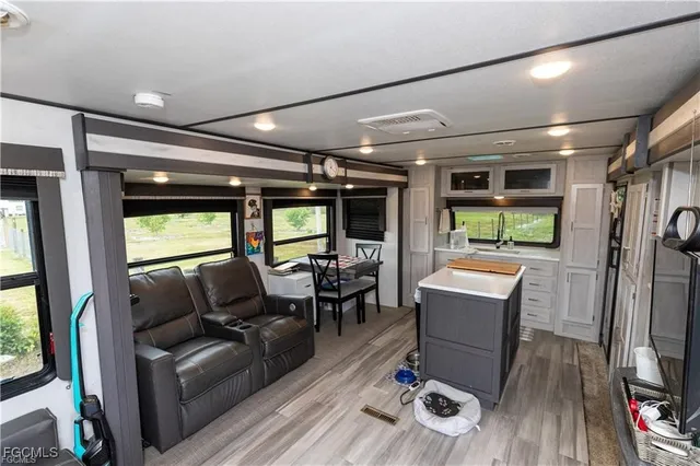 a living room with furniture a window and a flat screen tv