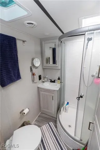 a bathroom with a sink mirror vanity and toilet
