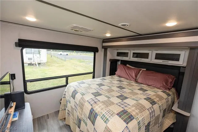 a bedroom with a large bed and a large window