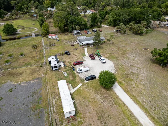 an aerial view of a house with a yard basket ball court