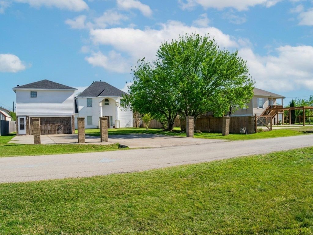 230 22nd Street Dickinson, TX 77539 - Photo 17 of 18 a view of a house with a big yard and large trees
