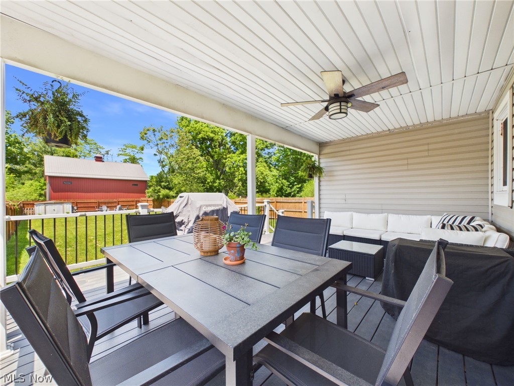 3490 County Line Road Madison, OH 44057 - Photo 27 of 42 Covered deck featuring a ceiling fan with light fixture, composite decking, and white railing