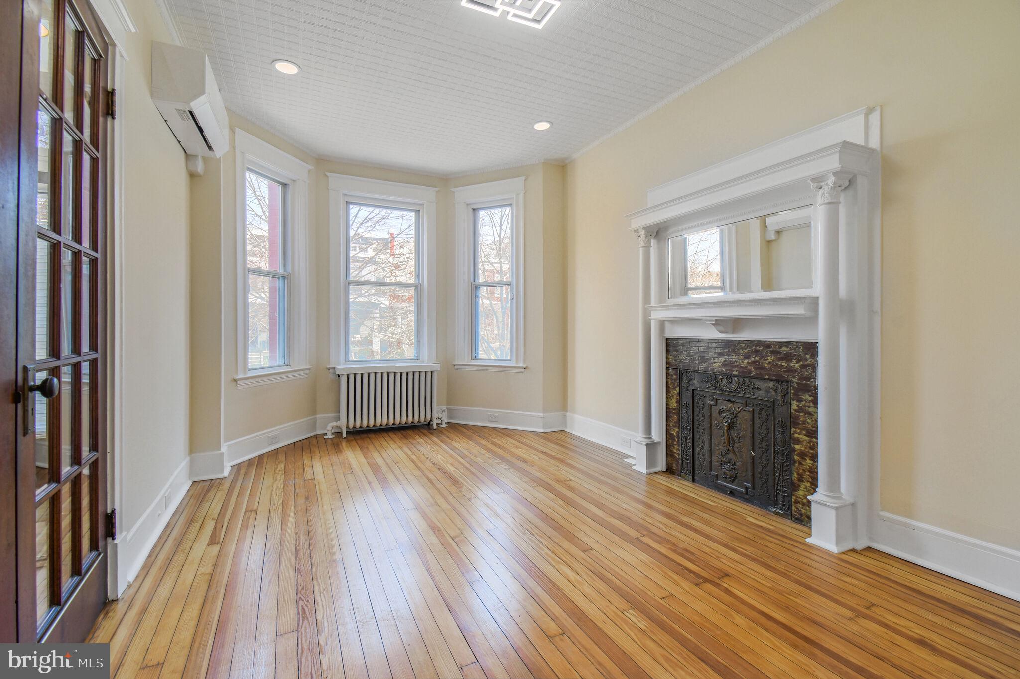 636 5th Street Northeast Washington, DC 20002 - Photo 3 of 16 a view of an empty room with wooden floor and a window