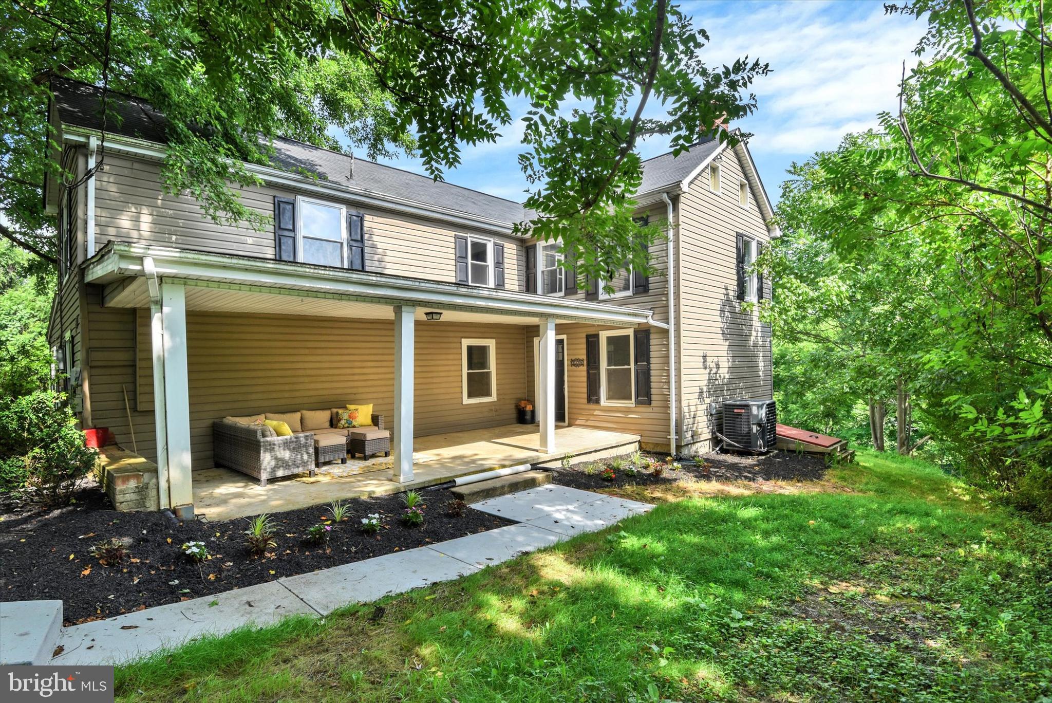 a view of a house with backyard sitting area and garden