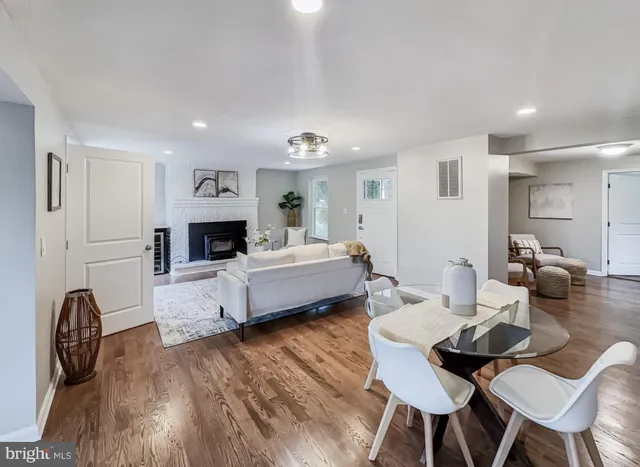 a living room with fireplace furniture and a wooden floor