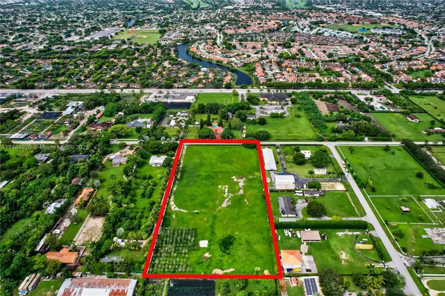 a view of yard with swimming pool and green space