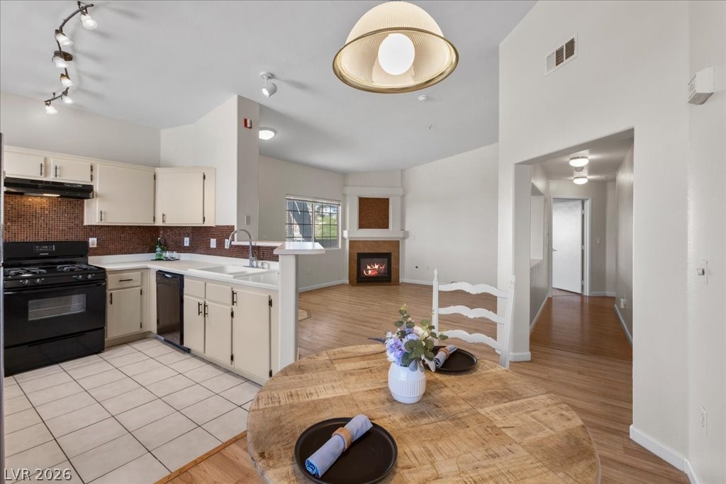 1881 West Alexander Road, Unit 1037 North Las Vegas, NV 89032 - Photo 31 of 31 An open concept floorplan seamlessly connects the well-equipped kitchen to the inviting living area with a fireplace.