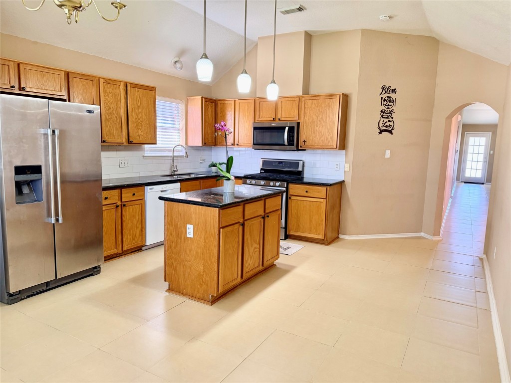 23023 Canal Road Richmond, TX 77406 - Photo 16 of 30 a kitchen with stainless steel appliances granite countertop a stove a refrigerator a sink a oven and a refrigerator