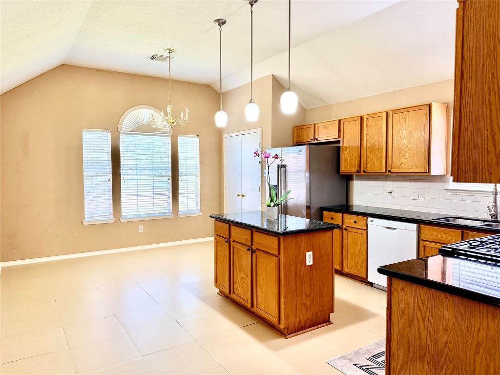 23023 Canal Road Richmond, TX 77406 - Photo 17 of 30 a kitchen with stainless steel appliances granite countertop a sink a stove and a wooden floors
