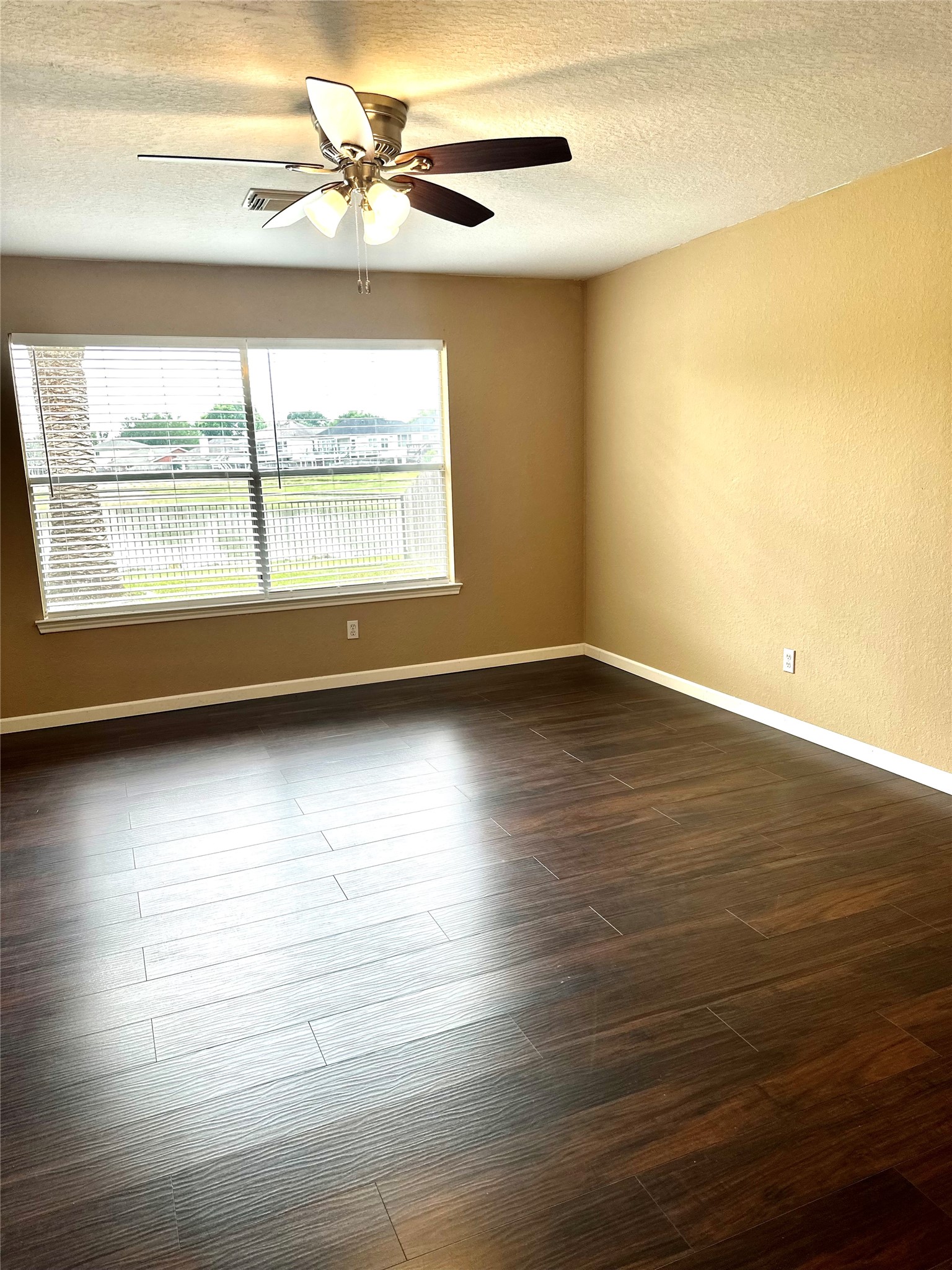 23023 Canal Road Richmond, TX 77406 - Photo 19 of 30 an empty room with wooden floor and windows