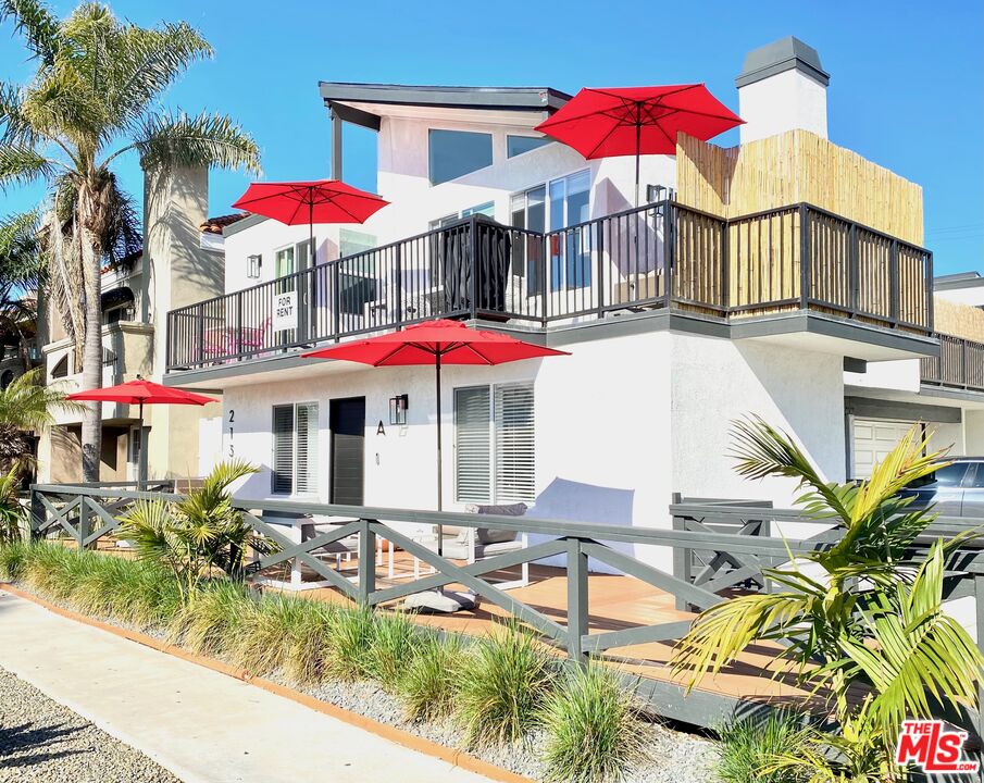 an outdoor space with pool and chairs