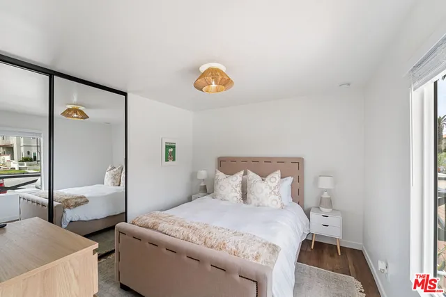 a bedroom with a bed and a lamp