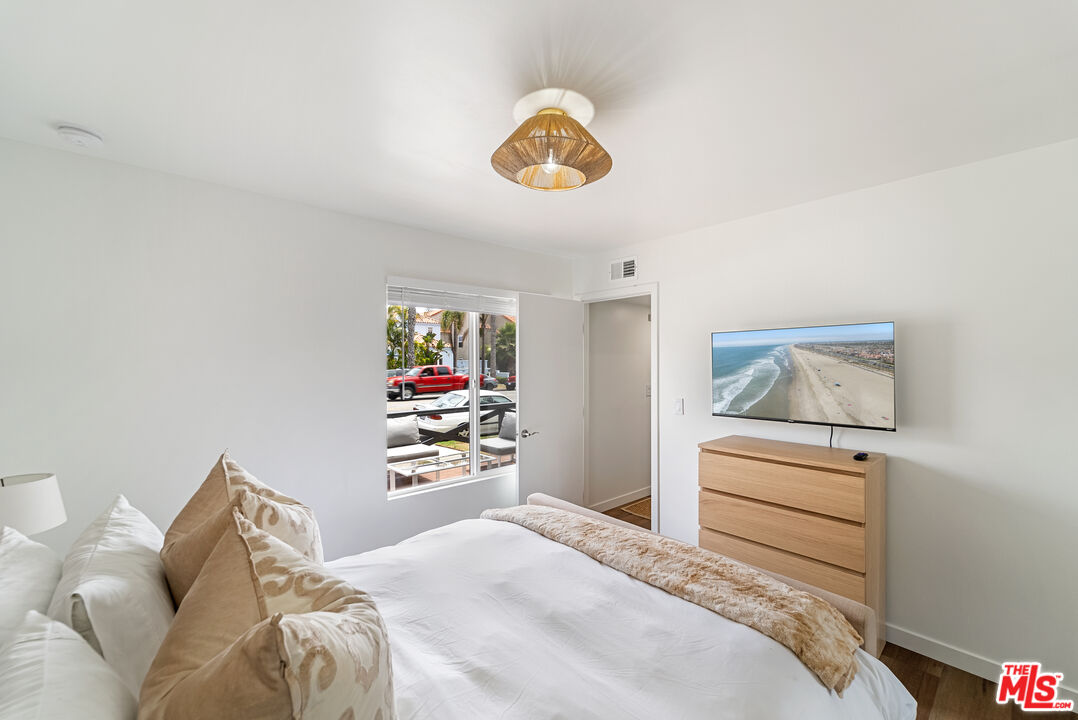 213 17th Street, Unit A Huntington Beach, CA 92648 - Photo 14 of 31 a bedroom with a bed and a window