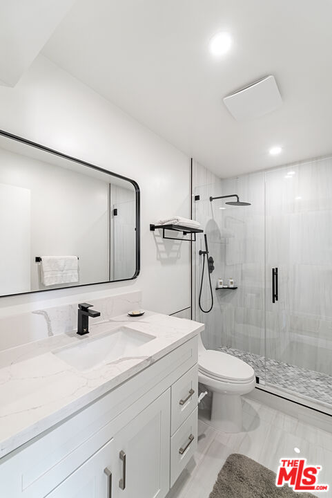 213 17th Street, Unit A Huntington Beach, CA 92648 - Photo 15 of 31 a bathroom with a granite countertop sink toilet and shower